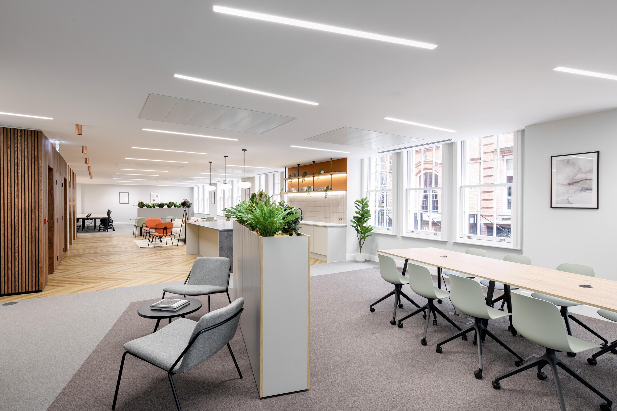 Flexible furniture layout for an Asset Management Firm’s Tenant-Ready™ workspace, including soft seating, collaborative tables, and planter dividers for natural zoning.