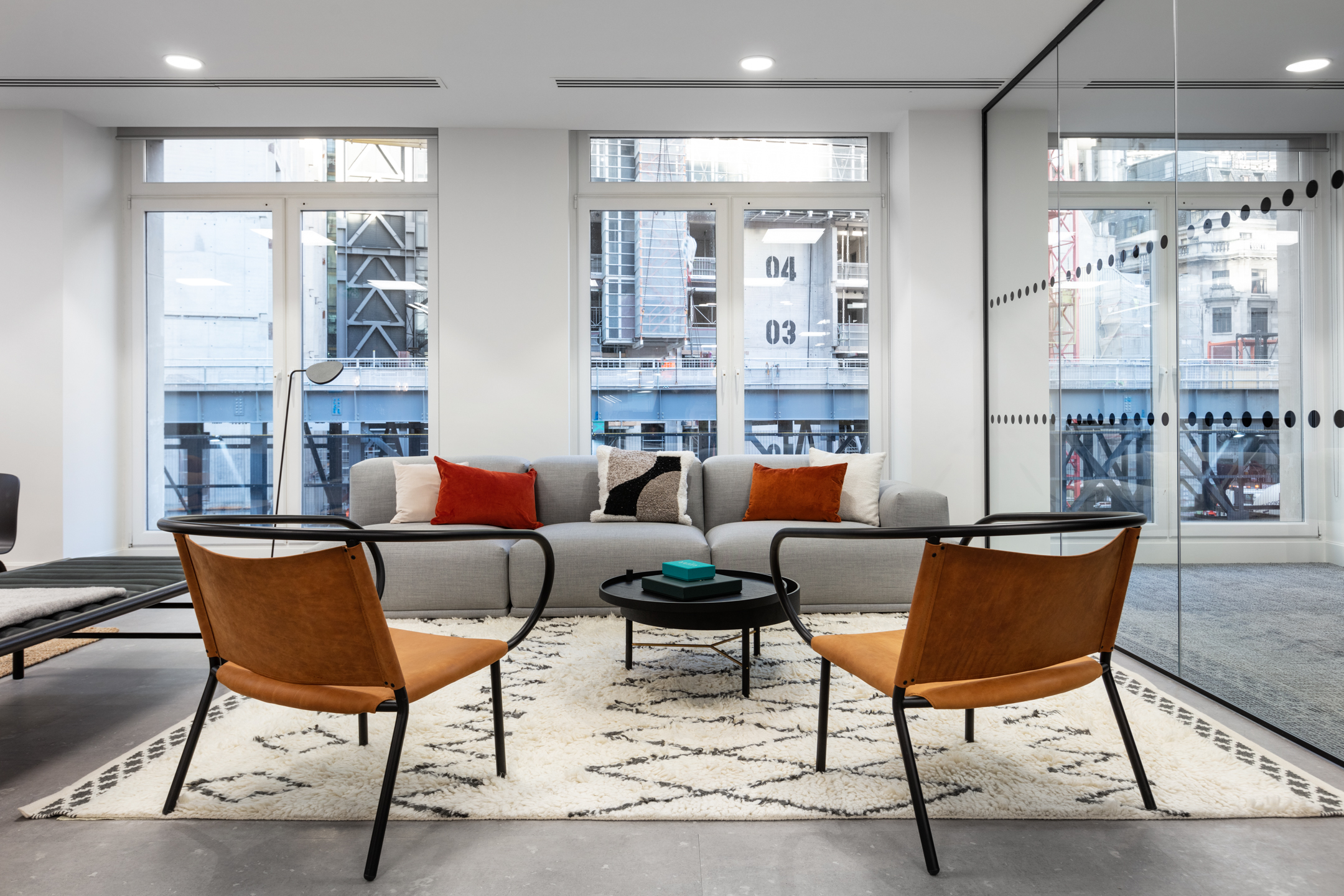 Breakout area at 7 Bishopsgate Level 2 for BGO, with Platfform-supplied soft seating and warm terracotta feature walls, forming a relaxed hub adjacent to the teapoint.