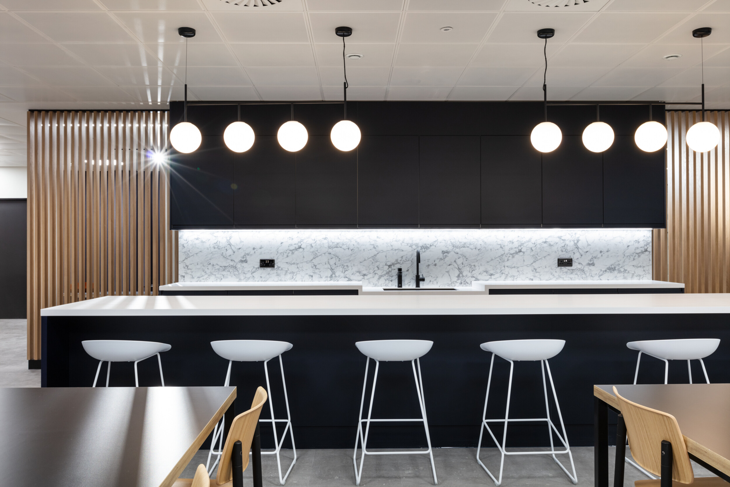 Kitchen island bar at 7 Bishopsgate Level 3, furnished by Platfform, with high stools and integrated counter seating designed to enhance social interaction within the teapoint area.