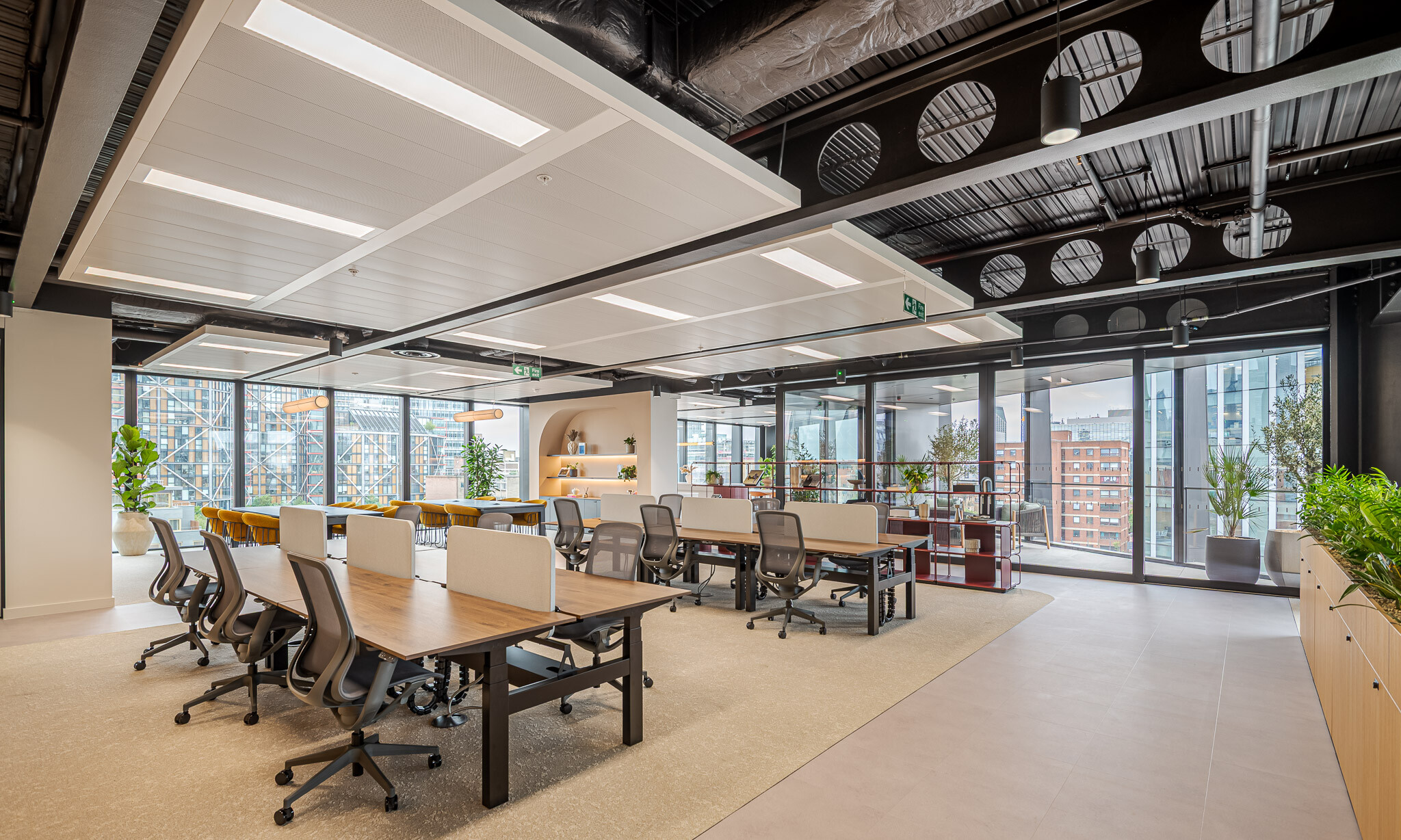 Spacious open-plan layout in Arbor’s Tenant-Ready™ workspace, furnished by Platfform, with dual banks of desks, mustard meeting chairs, burgundy shelving and views to the terrace.