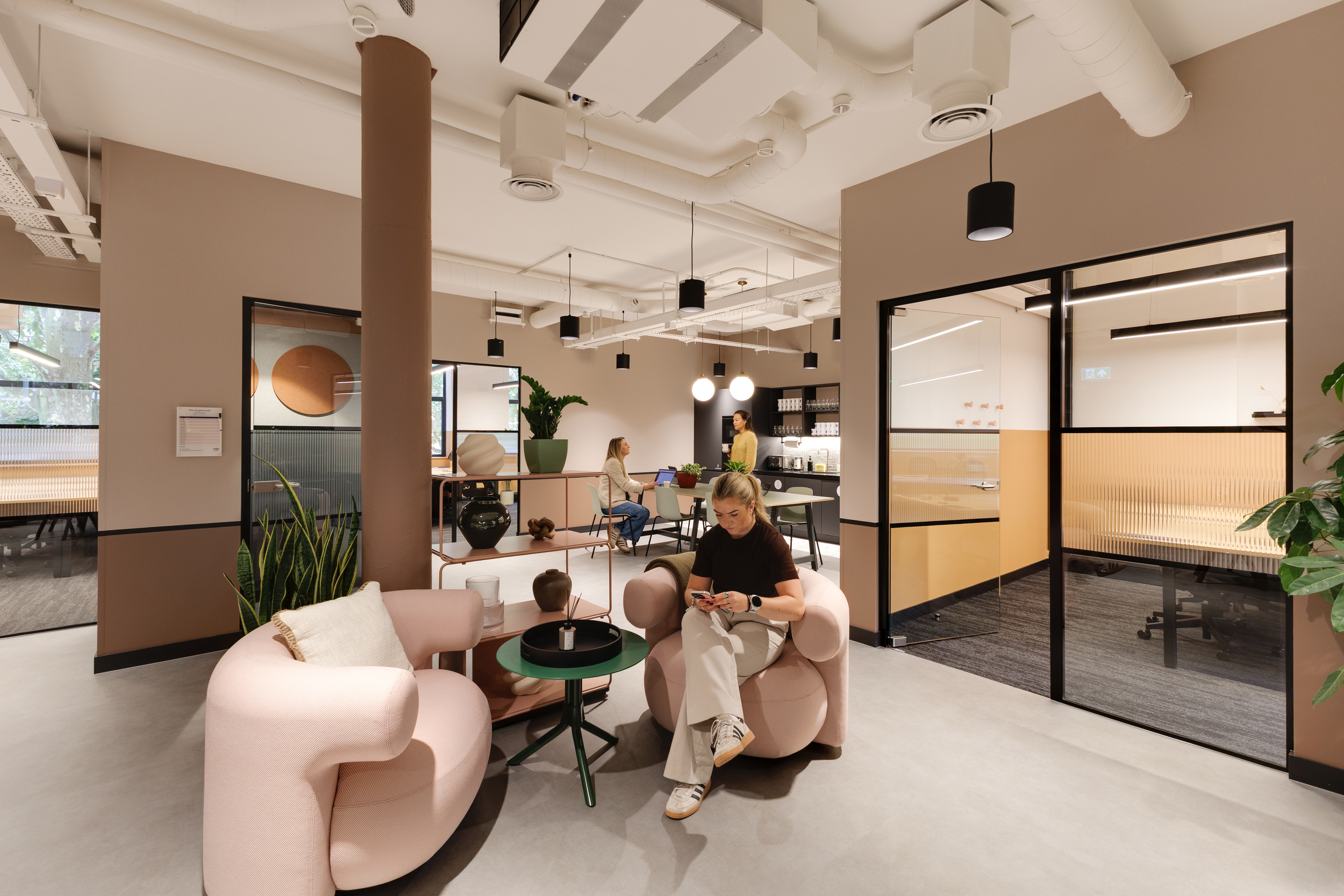 Level 2 teapoint at Work.Life Clerkenwell Green with soft pink seating and warm neutral tones, furnished by Platfform.
