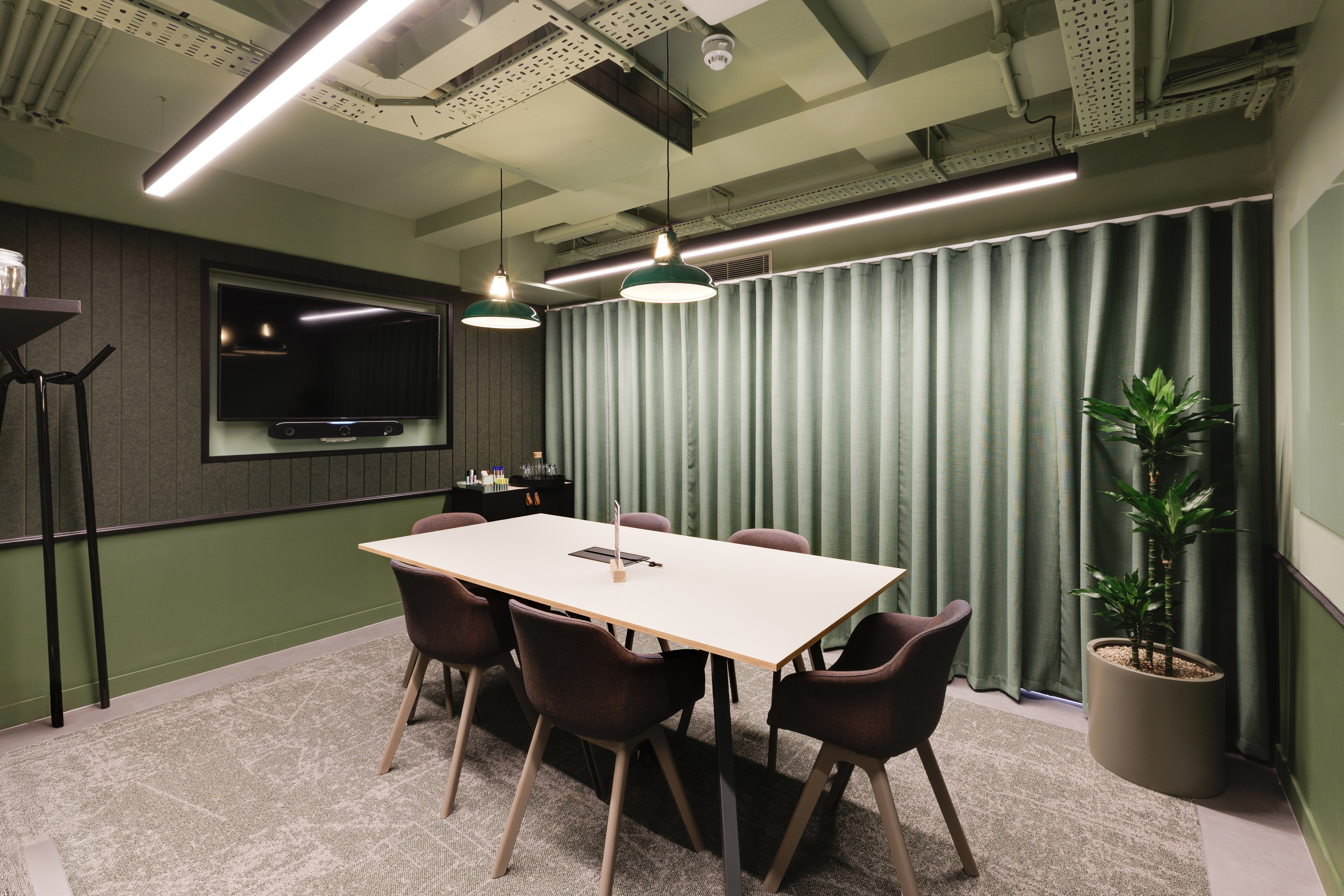 Lower ground meeting room at Work.Life Clerkenwell Green featuring soft green tones, textured curtains and modern meeting furniture supplied by Platfform.